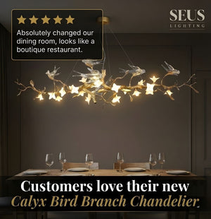 Calyx Bird Branch Chandelier in a dining room setting with SEUS Lighting branding.